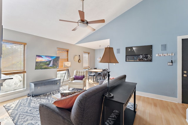 living room featuring high vaulted ceiling, ceiling fan, and light hardwood / wood-style flooring