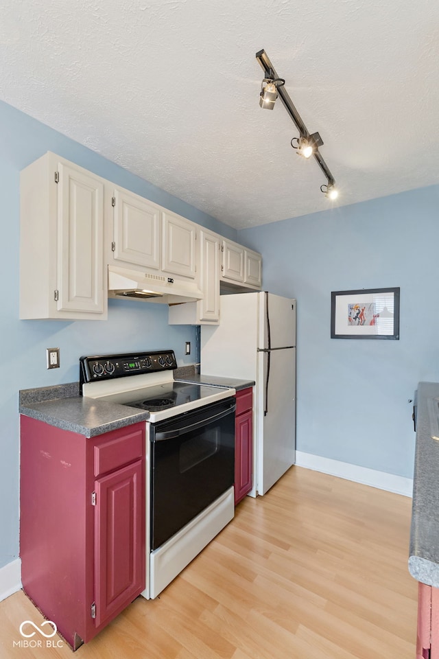 kitchen featuring electric range, white refrigerator, a textured ceiling, white cabinets, and light wood-type flooring