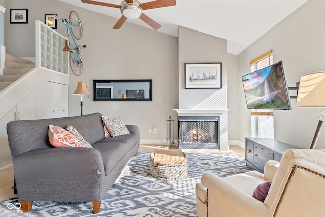 living room featuring vaulted ceiling and ceiling fan