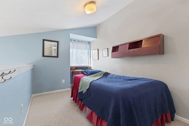 carpeted bedroom featuring lofted ceiling