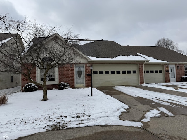 view of front of property featuring an attached garage and brick siding