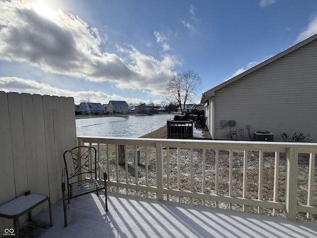 balcony featuring a water view and cooling unit