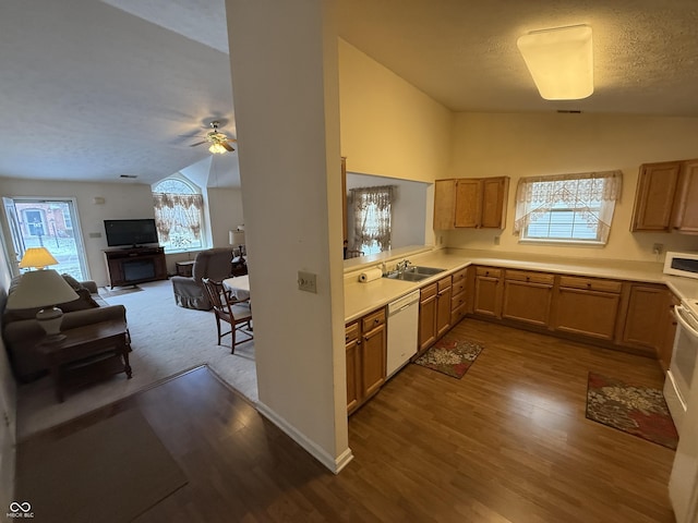 kitchen with open floor plan, light countertops, white appliances, and a sink