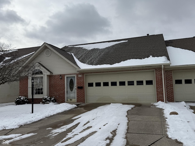 view of front of home featuring brick siding and an attached garage