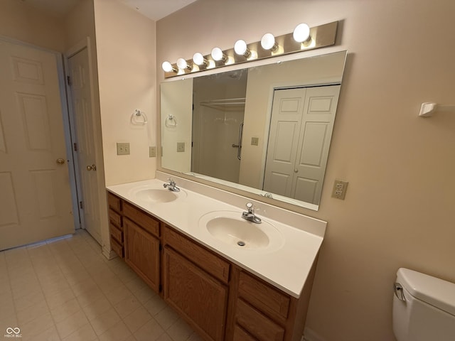 full bath with double vanity, a closet, a sink, and toilet