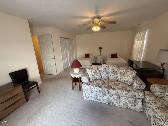 living room featuring carpet and a ceiling fan