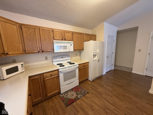 kitchen featuring white appliances, vaulted ceiling, light countertops, brown cabinetry, and dark wood finished floors