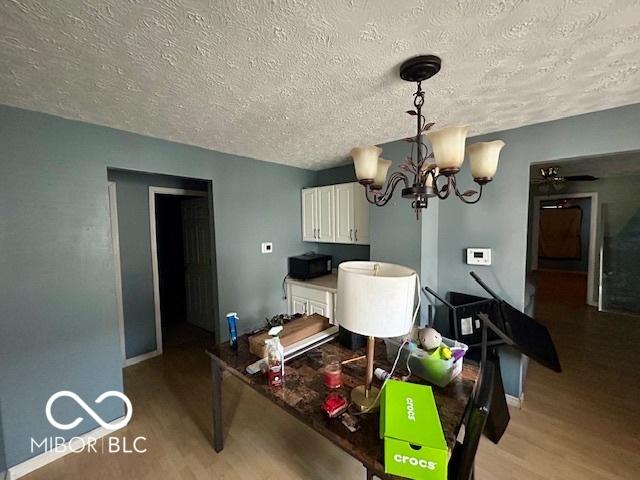 dining room featuring an inviting chandelier and light hardwood / wood-style flooring