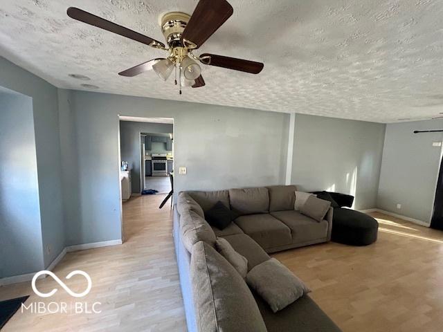 living room featuring a textured ceiling and light hardwood / wood-style floors