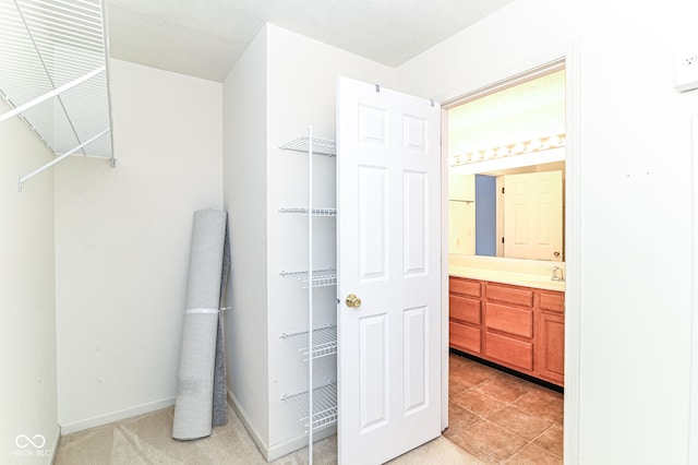 bathroom with baseboards, vanity, and a textured ceiling