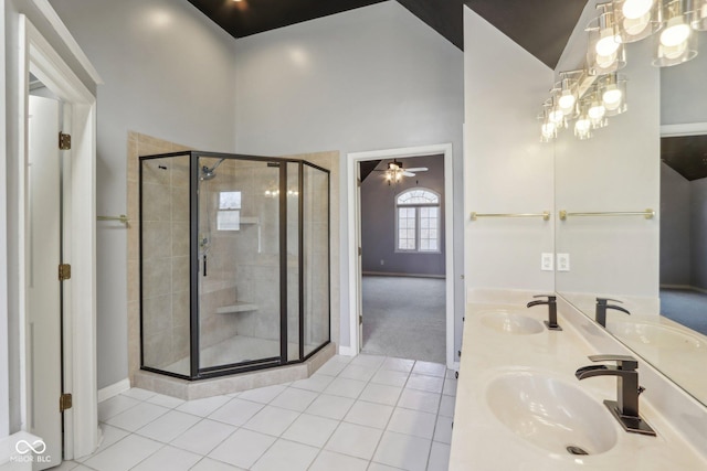 full bath with tile patterned floors, a shower stall, and a sink