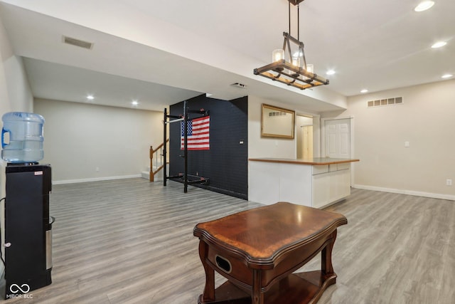 playroom with visible vents, baseboards, and light wood finished floors