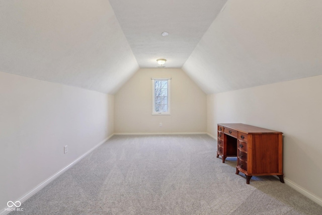 bonus room with baseboards, light carpet, and vaulted ceiling