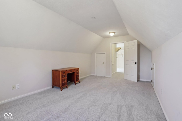 additional living space with lofted ceiling, carpet, and baseboards