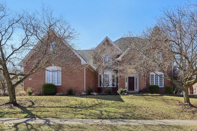 view of front of property with brick siding and a front lawn