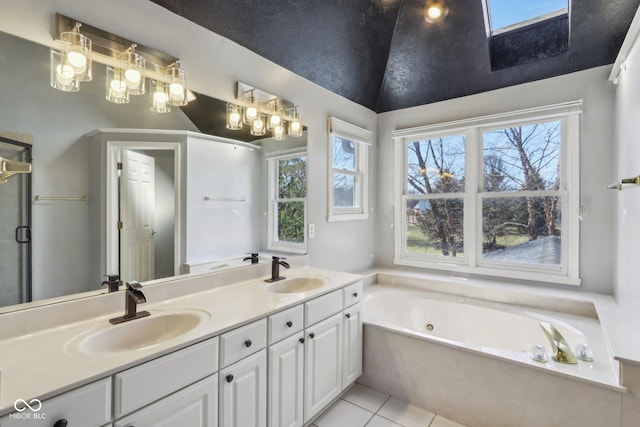 full bath with tile patterned floors, a whirlpool tub, double vanity, and a sink