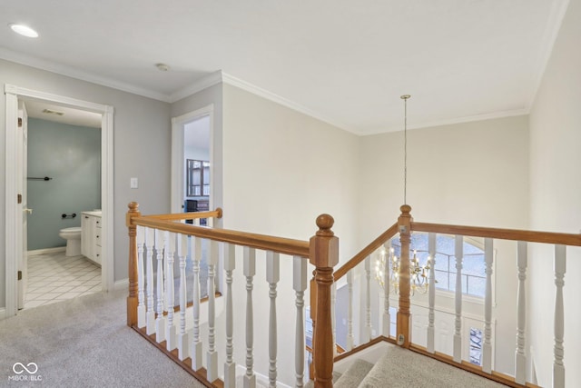 hall with an upstairs landing, carpet, and ornamental molding