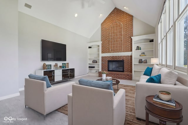 living area with carpet, visible vents, baseboards, high vaulted ceiling, and a brick fireplace