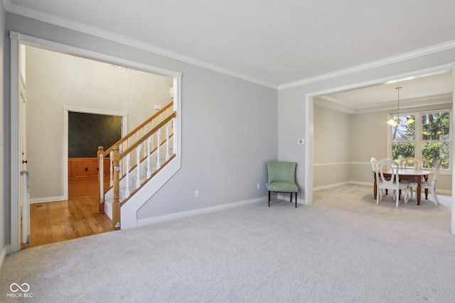 sitting room featuring a chandelier, stairway, carpet, and ornamental molding