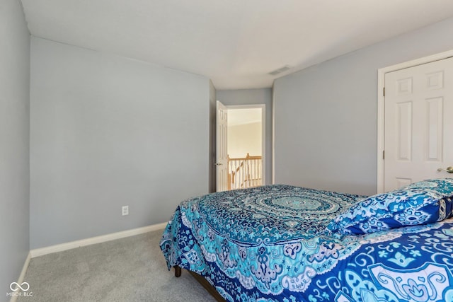 bedroom featuring visible vents, baseboards, and carpet