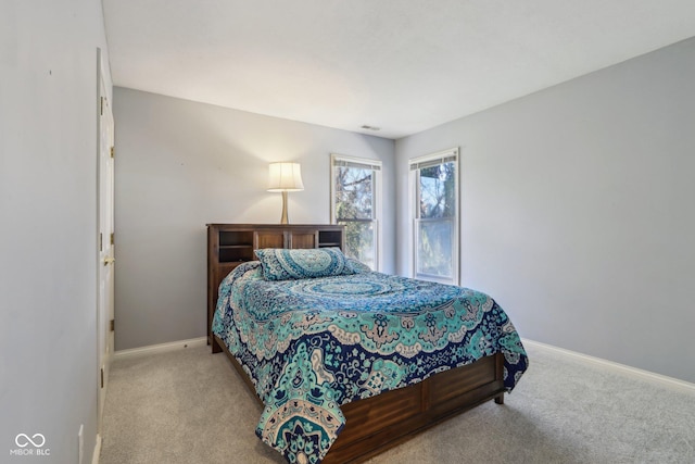 carpeted bedroom featuring visible vents and baseboards