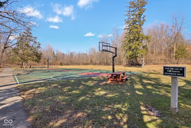 view of sport court featuring community basketball court, a lawn, and fence