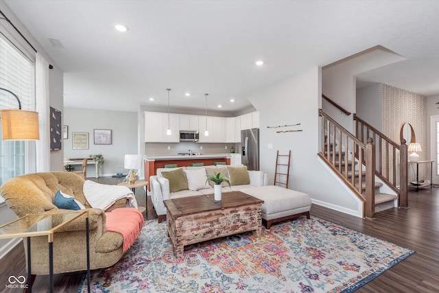 living area featuring dark wood-style floors, recessed lighting, stairway, and baseboards