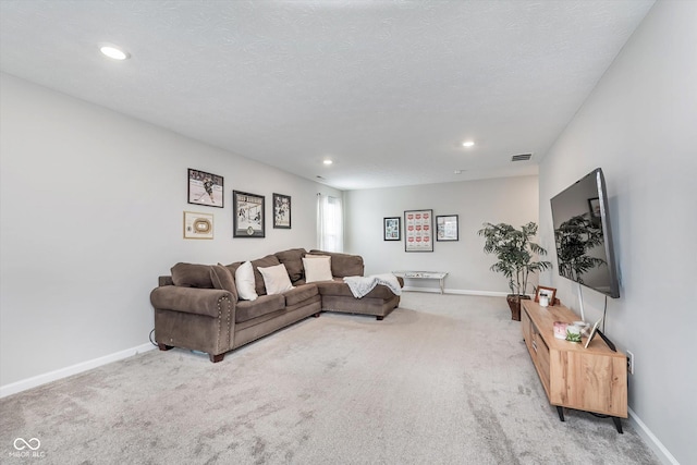 carpeted living area featuring recessed lighting, visible vents, a textured ceiling, and baseboards