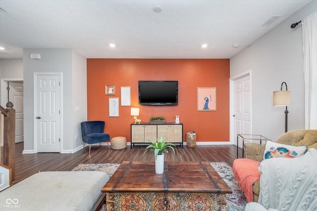 living room featuring recessed lighting, baseboards, and wood finished floors