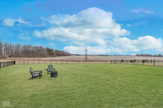 view of yard with a rural view and fence