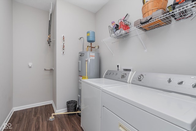 laundry area featuring laundry area, baseboards, dark wood-style floors, electric water heater, and washing machine and clothes dryer