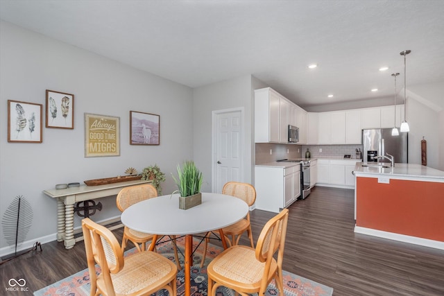 dining space featuring dark wood-type flooring, recessed lighting, and baseboards