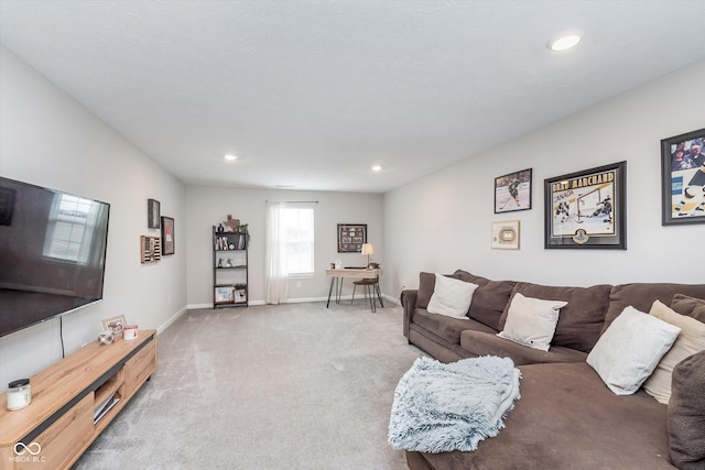 carpeted living area with recessed lighting and baseboards