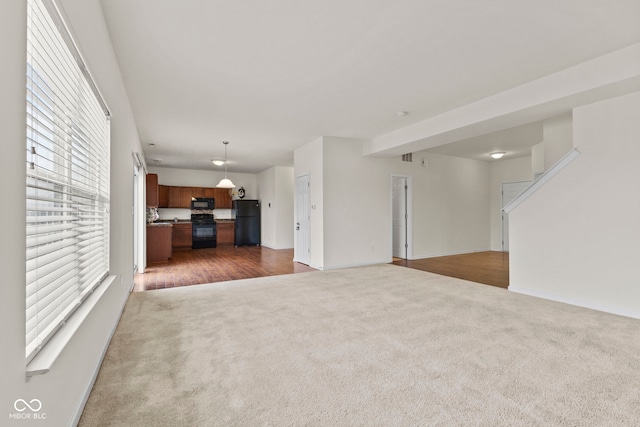 unfurnished living room with dark carpet