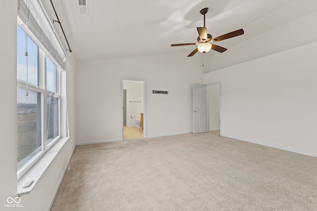 spare room featuring ceiling fan, light carpet, and high vaulted ceiling