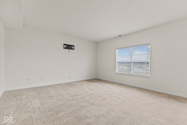 unfurnished room featuring light colored carpet