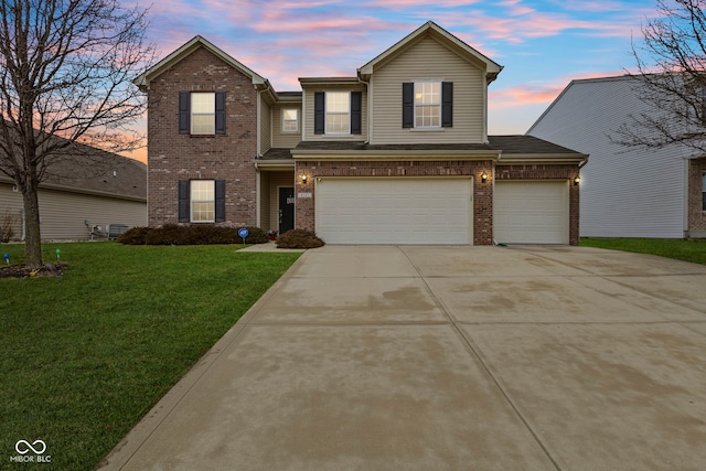 view of front of property featuring a garage and a yard