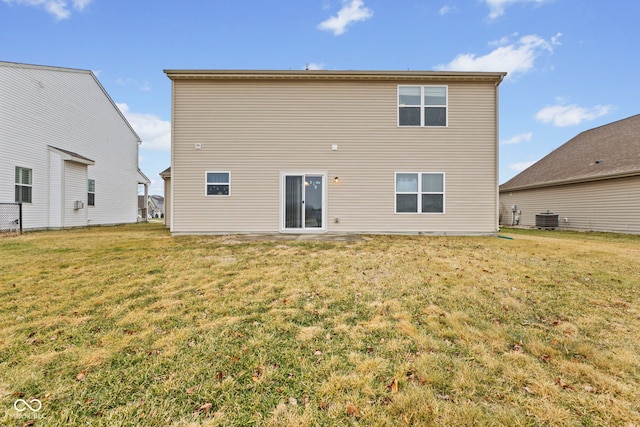 back of house with a yard and central AC unit