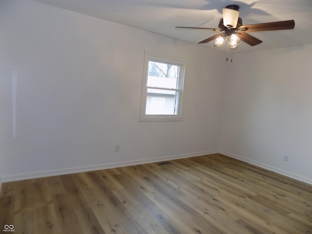 empty room with hardwood / wood-style flooring and ceiling fan