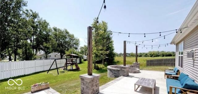 view of patio with an outdoor living space with a fire pit, a playground, and fence