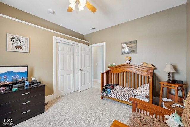 bedroom featuring a closet, light colored carpet, visible vents, ceiling fan, and baseboards