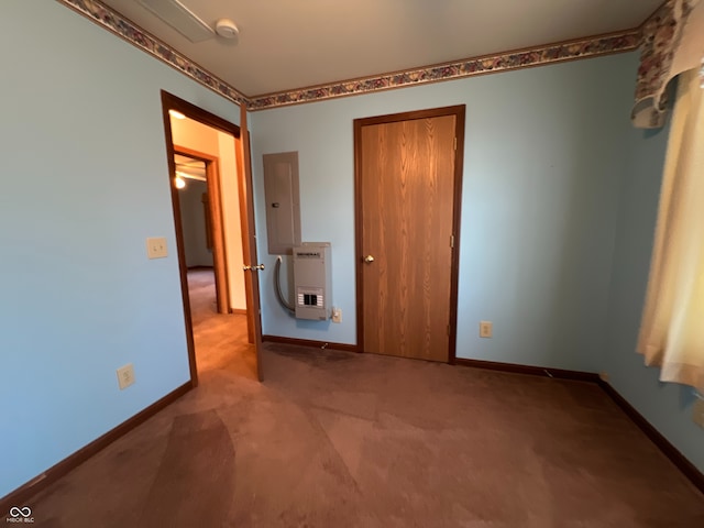 unfurnished bedroom featuring electric panel, heating unit, and carpet