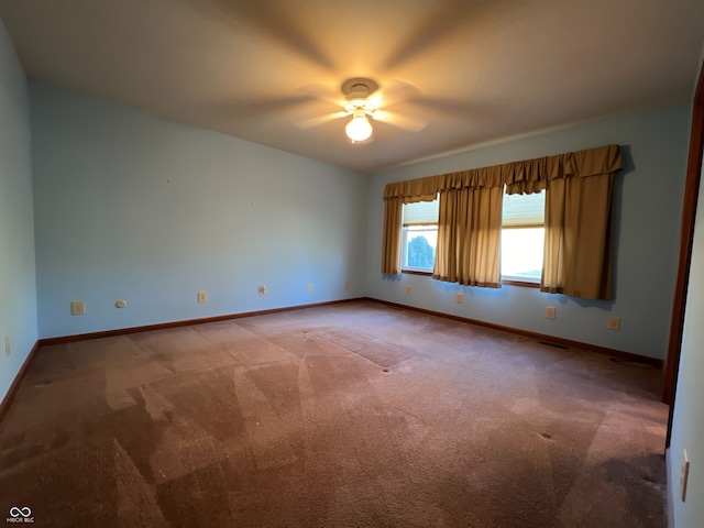 unfurnished room featuring ceiling fan and carpet floors