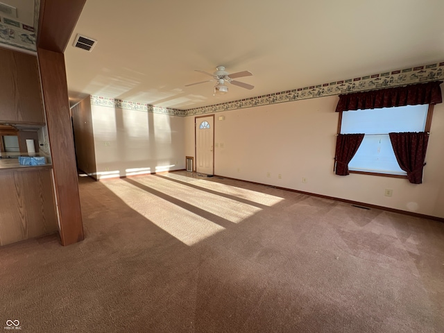 carpeted spare room featuring ceiling fan