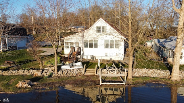 view of front of property featuring a water view and a boat dock