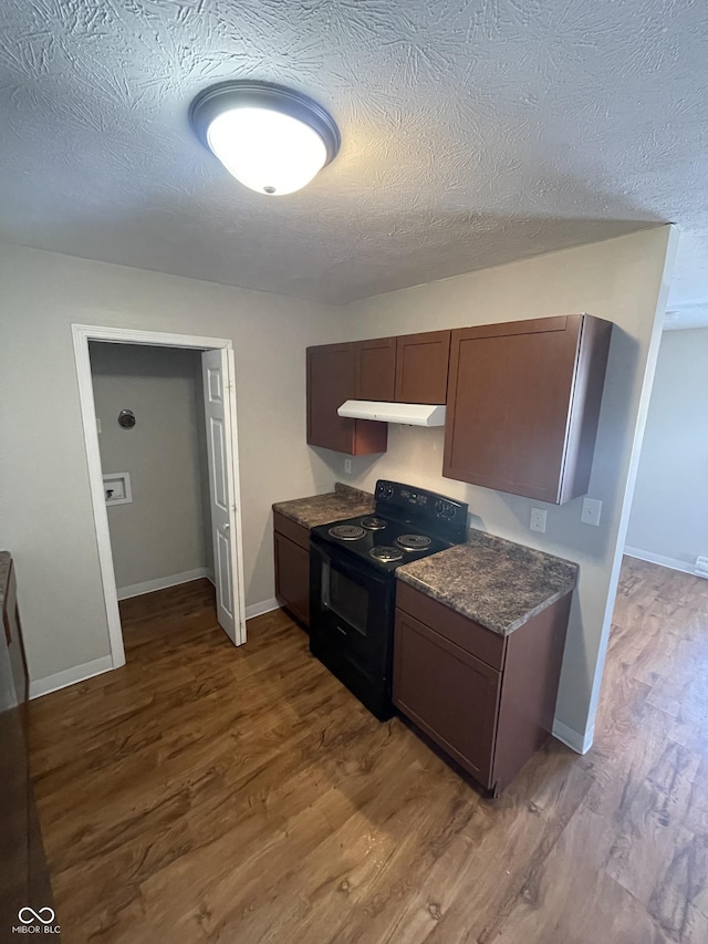 kitchen featuring dark brown cabinetry, wood-type flooring, black range with electric cooktop, and a textured ceiling