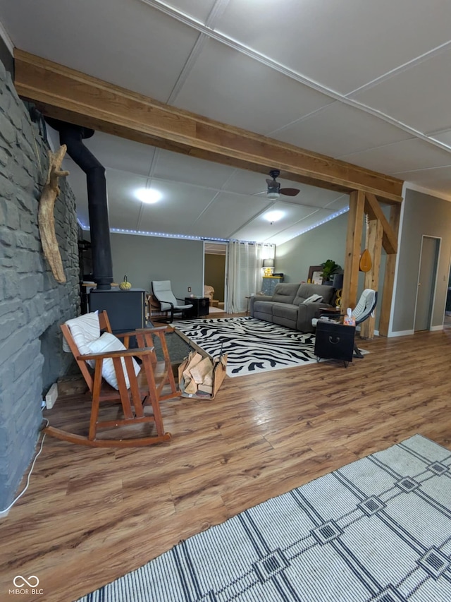 living room featuring beam ceiling, wood-type flooring, and ceiling fan