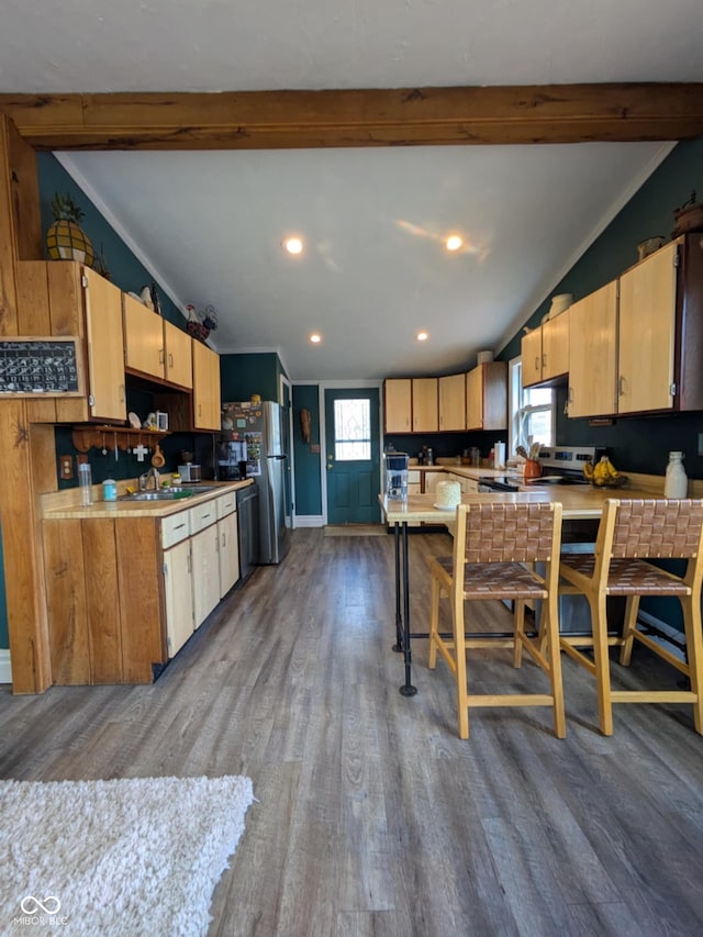 kitchen featuring lofted ceiling with beams, plenty of natural light, and hardwood / wood-style flooring