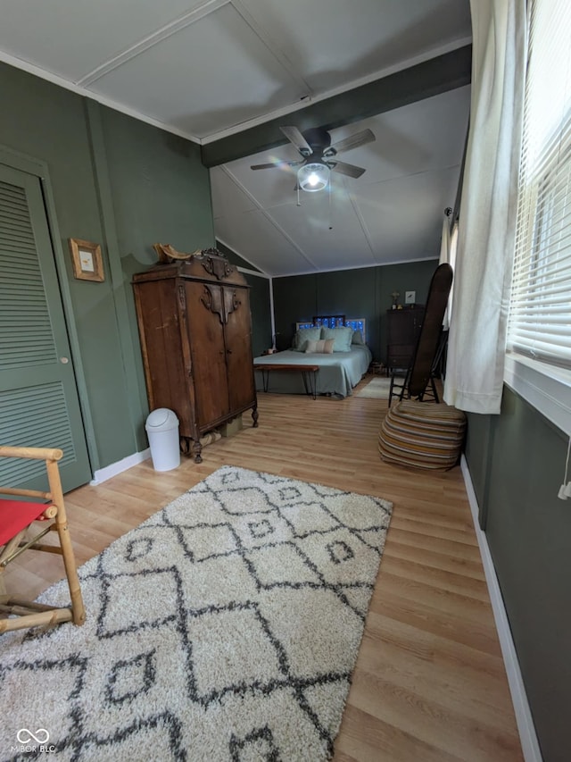 bedroom with lofted ceiling with beams, hardwood / wood-style floors, and ceiling fan