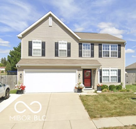 view of front of home with a front yard and a garage